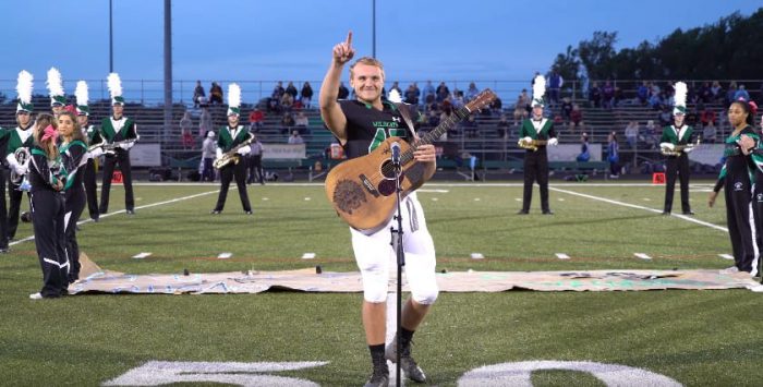 No one was willing to sing the national anthem, so one high schooler took off his helmet and grabbed a guitar